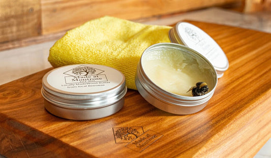 Made at Montrose Wood Butter in a 100ml tin displayed with a handmade wooden chopping board, for regular wood care and maintenance.