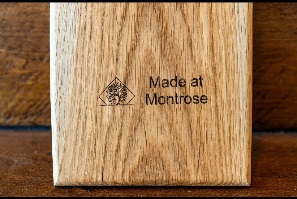 Handcrafted wooden charcuterie and serving boards with long handles and beautiful natural hardwood grain, made by Made at Montrose in Lancashire.