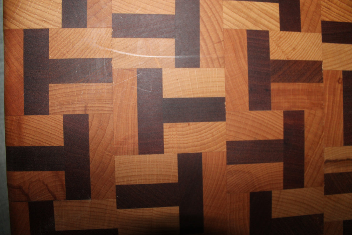 Detailed view of the limited edition end grain chopping board, highlighting the interlocking T-shaped pattern of beech and sapele wood.