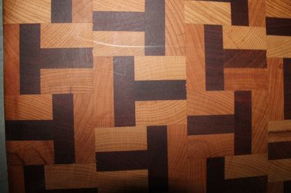 Detailed view of the limited edition end grain chopping board, highlighting the interlocking T-shaped pattern of beech and sapele wood.