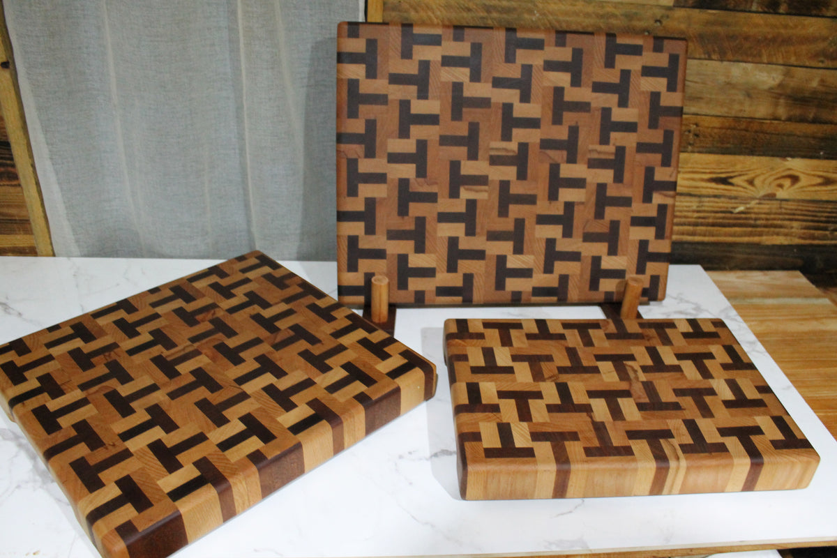 Limited edition beech and sapele end grain chopping boards displayed together, showing their distinctive T-shape wood patterns.