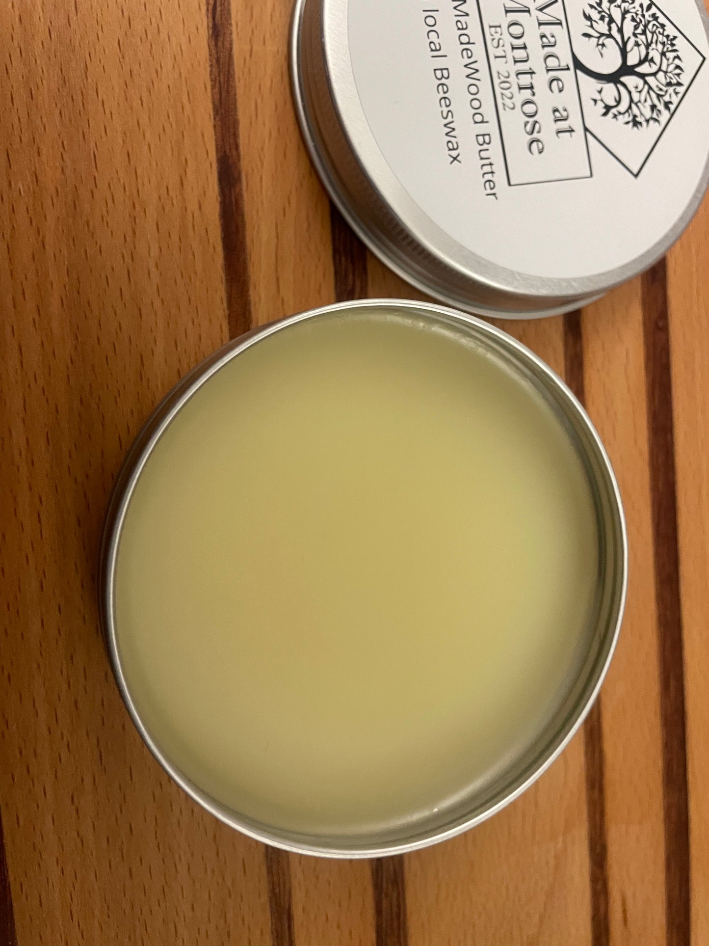 open 100ml tin of Made at Montrose Wood Butter showing beeswax-based wooden chopping board conditioner, viewed from above. 