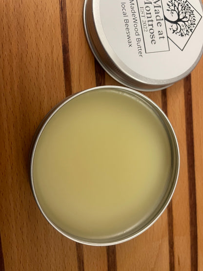 open 100ml tin of Made at Montrose Wood Butter showing beeswax-based wooden chopping board conditioner, viewed from above. 