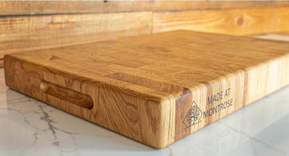 Angled view of the Montrose Edition solid oak end grain chopping board, showing its natural wood grain and handcrafted finish