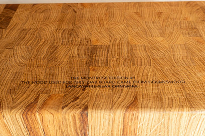 Side view of the Montrose Edition solid oak end grain chopping board, highlighting its substantial thickness and natural oak finish.