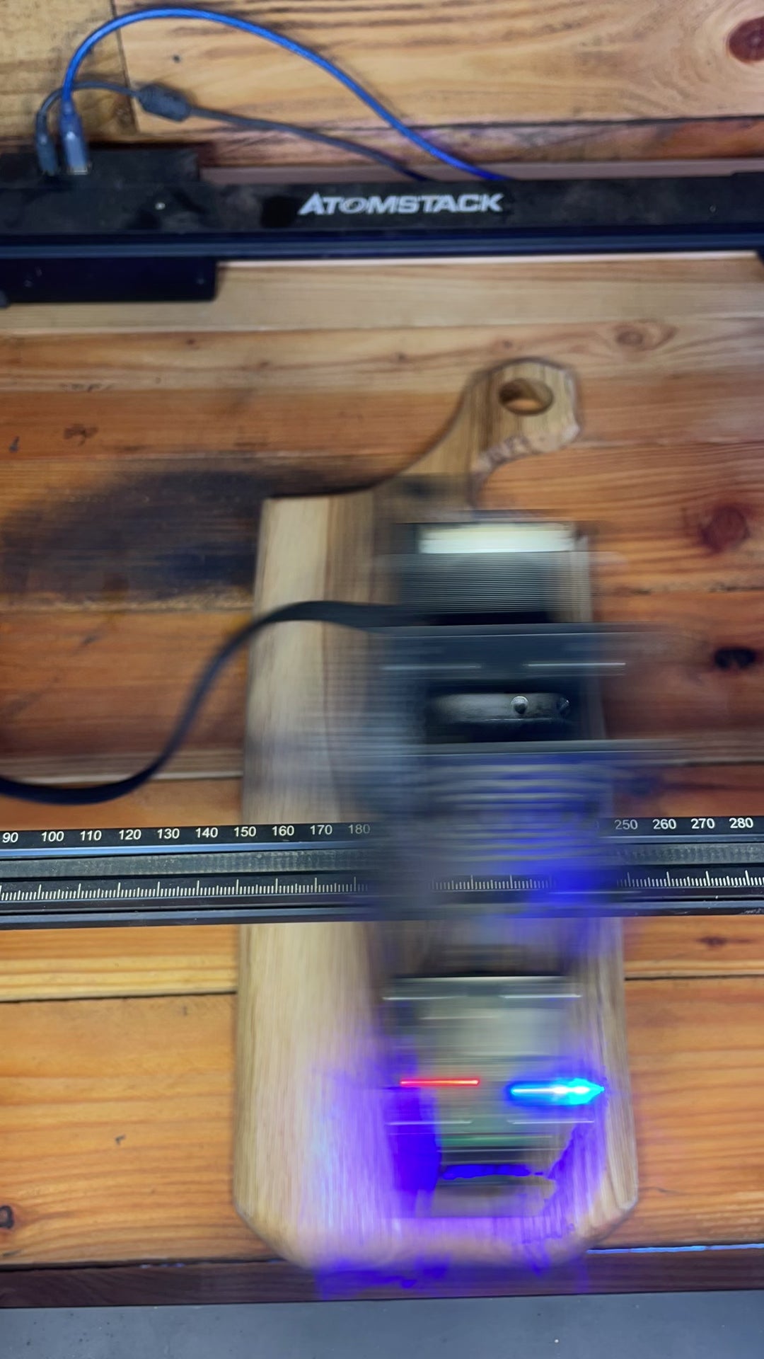 Laser engraving the Made at Montrose logo onto a handmade board in our Lancashire workshop.